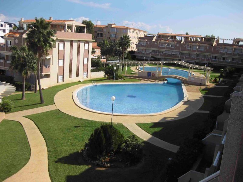 Overzicht op gemeenschappelijke tuin en zwembad van Appartement Te koop in Denia in Spanje, gelegen aan de Costa Blanca-Noord